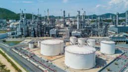 tanks with refinery in background